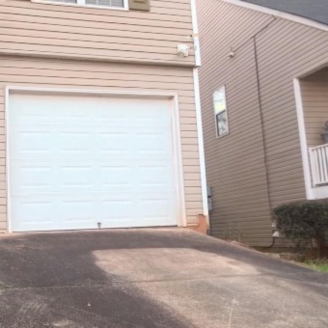 What happens when a woman's car is mistakenly towed from her own driveway?