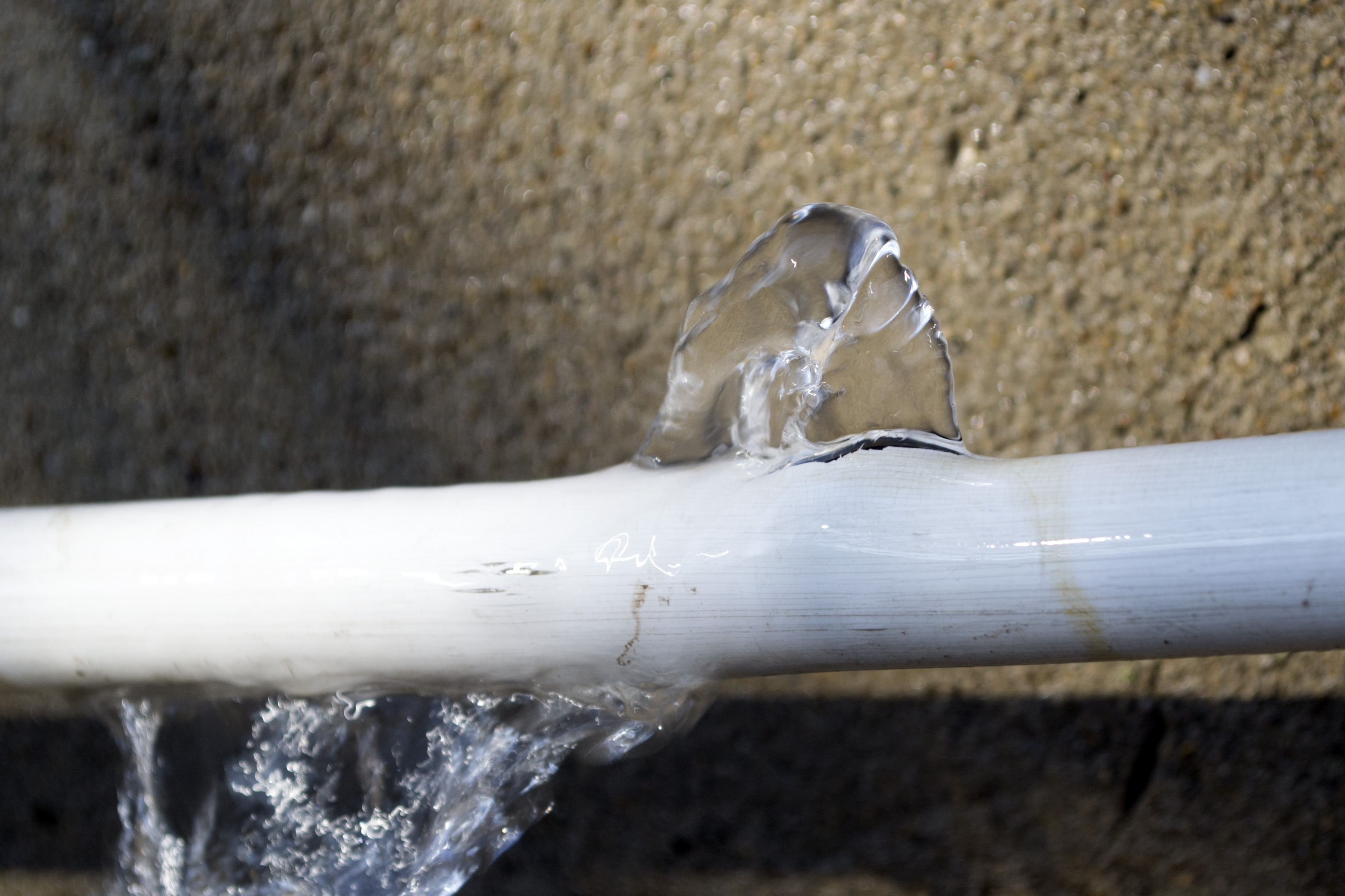 Water flowing out of burst pipe