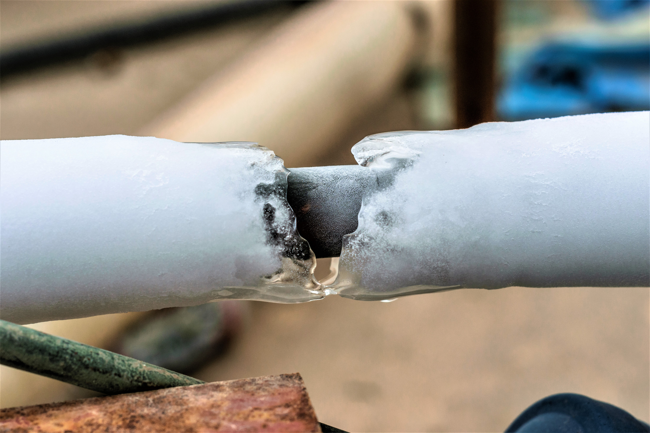 Frozen water surrounding leaking pipe